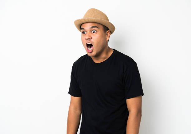 istock Young asian man with hat feels shock and surprise with overly face expression and looking on blank space. 1142974733