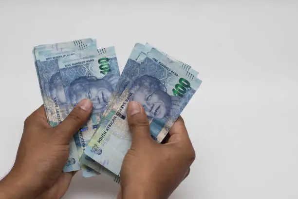 Hands counting south african rands