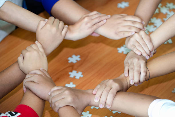 istock Young team putting hands up for new startup in creative office,  Team Teamwork Togetherness Collaboration Co-working and teamwork concept 1142975408