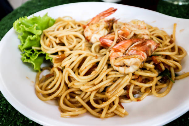 istock Closeup of Spaghetti with spicy prawn on white dish 1142982200