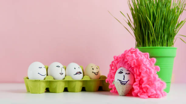 istock Funny easter faces on egss and one egg with a pink wig 1142982324