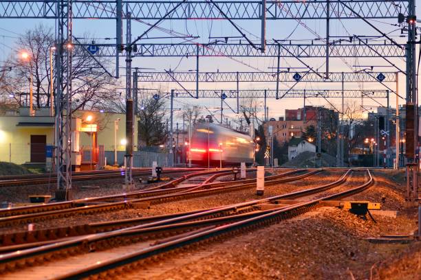 istock Passenger train on railroad tracks at the sunrise - blurred motion 1142982402