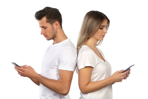istock Pair stands back to back and uses his smartphones 1142983900