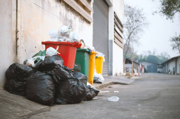 istock garbage bag black and trash bin with soft-focus and overlight in the background 1142984197