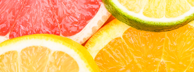 Colorful Citrus fresh fruits including grapefruit, lime, lemon and orange cross section studio shot