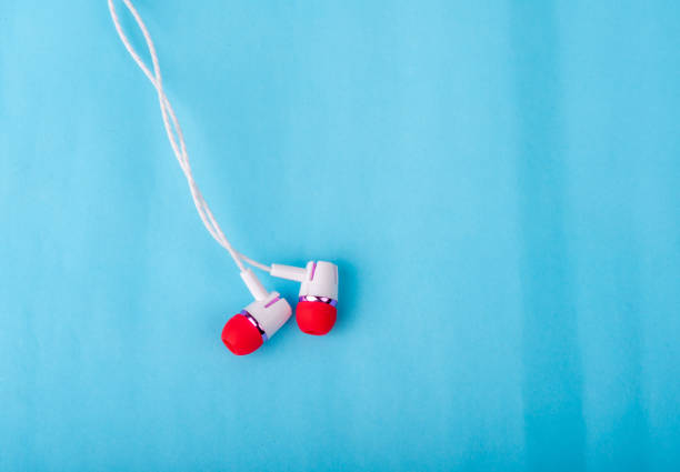 istock White red in-ear headphones on the background 1142987905