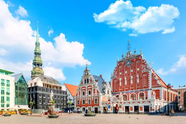 Photo of View of the Old Town Ratslaukums square, Roland Statue, The Blackheads House near St Peters Cathedral against blue sky in Riga, Latvia. Summer sunny day