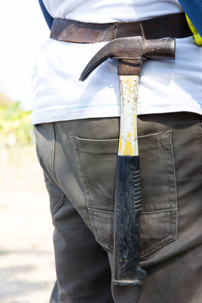 istock Rear View Of Man With Hammer 1142989034