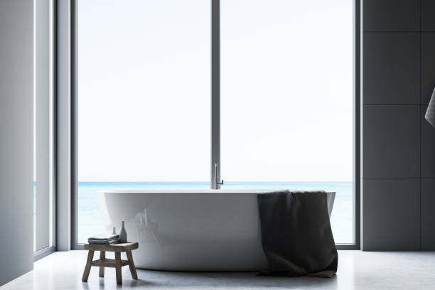 istock Gray tile bathroom interior with tub 1142993124