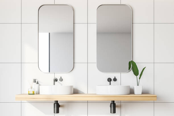 istock Close up of white tile bathroom with double sink 1142993398