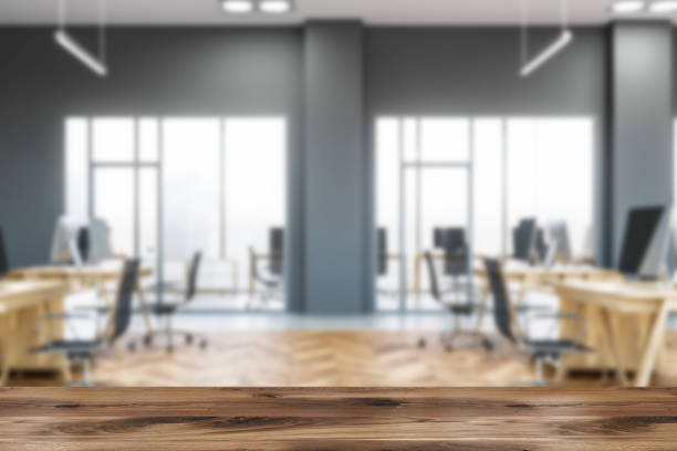 istock Side view of modern office with gray walls blur 1142994997
