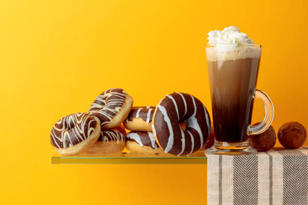 istock Chocolate donuts and coffee cocktail with cream. 1142996370