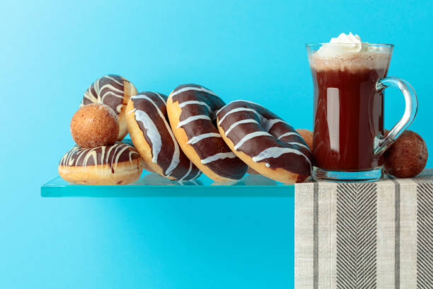 istock Chocolate donuts and hot chocolate with cream. 1142996385