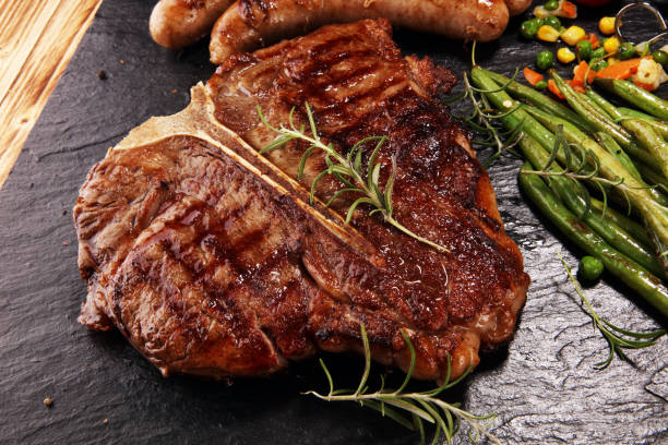 istock Assorted delicious grilled meat with vegetable on a barbecue with steak 1143001832