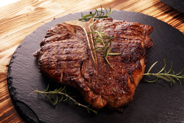 istock Grilled T-bone steak on stone cutting board. 1143002169