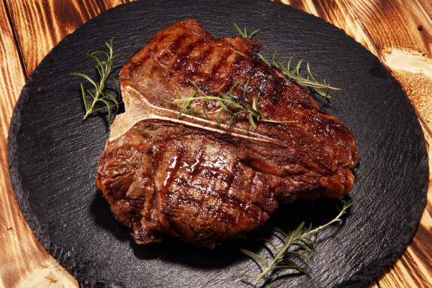 istock Grilled T-bone steak on stone cutting board. 1143003377