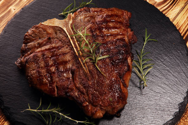 istock Grilled T-bone steak on stone cutting board. 1143003449