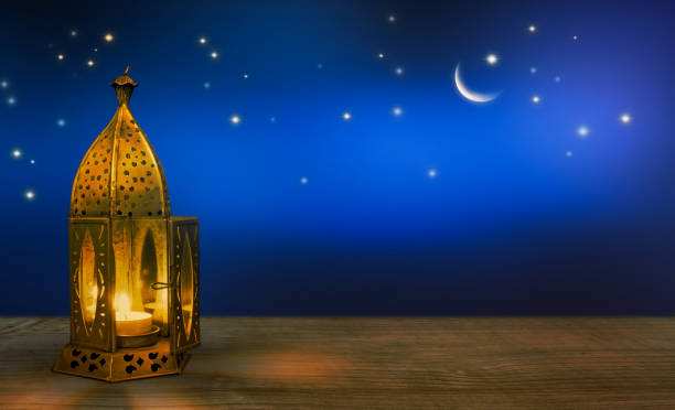 istock lantern on wooden table at night 1143003538