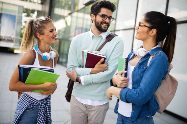 istock Happy group of friends studying and talking together at university 1143005222
