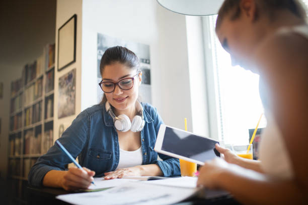istock Happy university friends studying together in college 1143005329