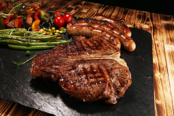 istock Assorted delicious grilled meat with vegetable on a barbecue with steak 1143006402