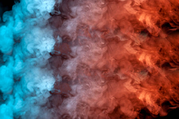 istock Translucent, thick smoke, illuminated by light against a dark background, divided into three colors: blue, green, pink and purple, burns out, evaporating from a steam of vape for print on t-shirt 1143007555