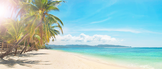 panoramic image of sunny day on white sand tropical beach, Boracay island, the Philippines