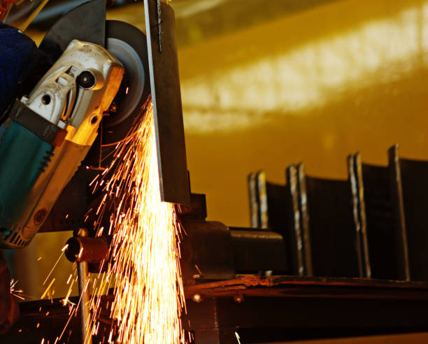 istock Angle grinder operating in factory creates sparks 1143008898