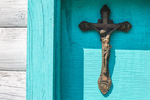 istock Old rusty metal cross isolated on blue 1143009683