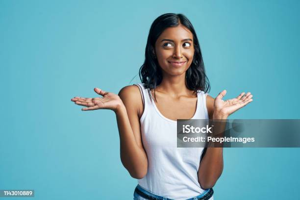 Just A Shrug Of The Shoulders Stock Photo - Download Image Now - Portrait, Colored Background, Women
