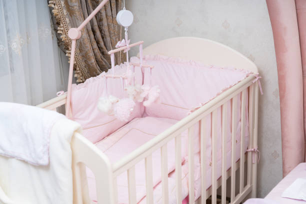 istock Empty white wooden cot in a nursery 1143013479