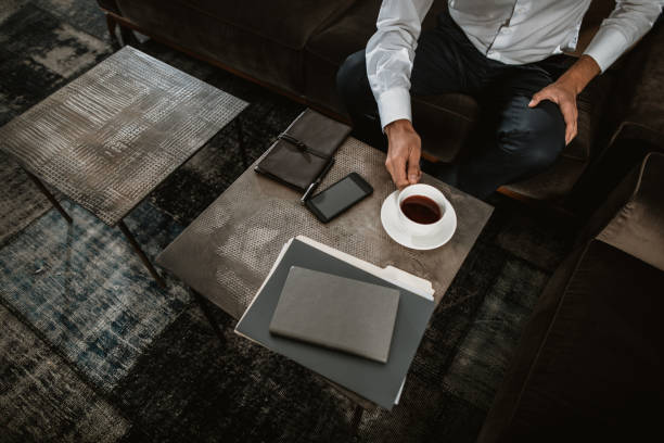 istock Businessman is relaxing with hot drink on sofa 1143014105