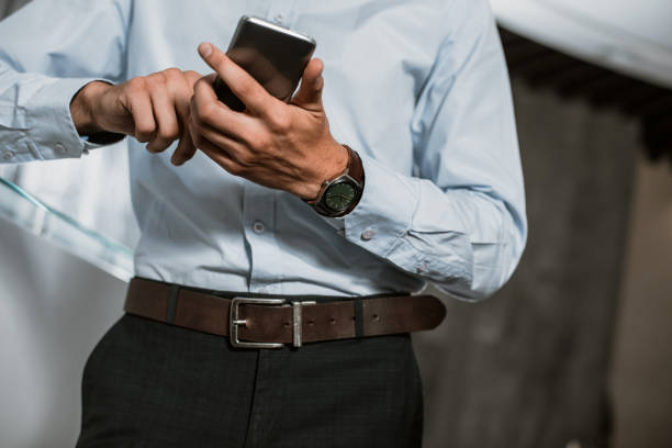 istock Office employee is exploiting his mobile phone 1143014137