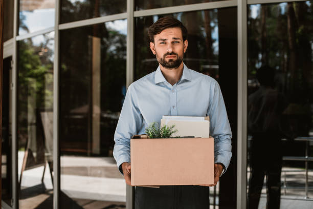 istock Sad laid off executive is leaving workplace with stuff 1143014141