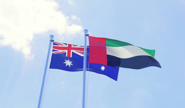 istock Australia and UAE, two flags waving against blue sky 1143015722