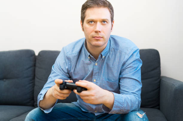 istock Man playing video game with gamepad in hands. 1143016628