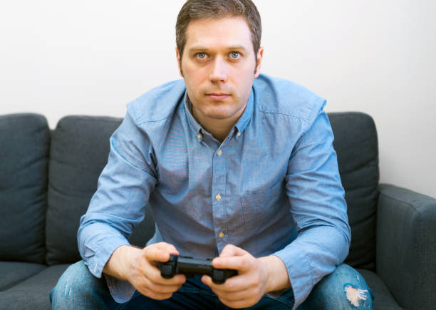 istock Man playing video game with gamepad in hands. 1143016630
