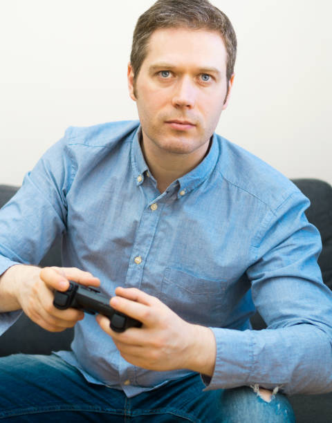 istock Man playing video game with gamepad in hands. 1143016631