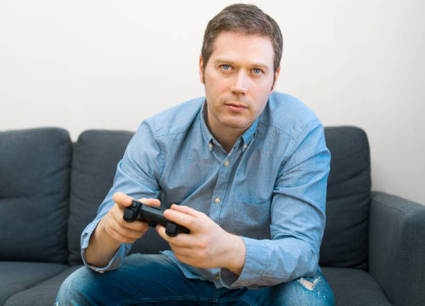 istock Man playing video game with gamepad in hands. 1143016636