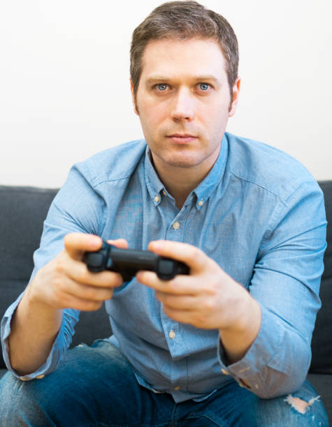 istock Man playing video game with gamepad in hands. 1143016638
