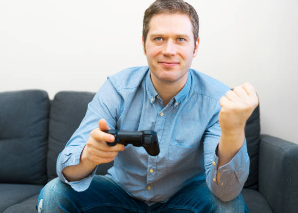 istock Man playing video game with gamepad in hands. 1143016645
