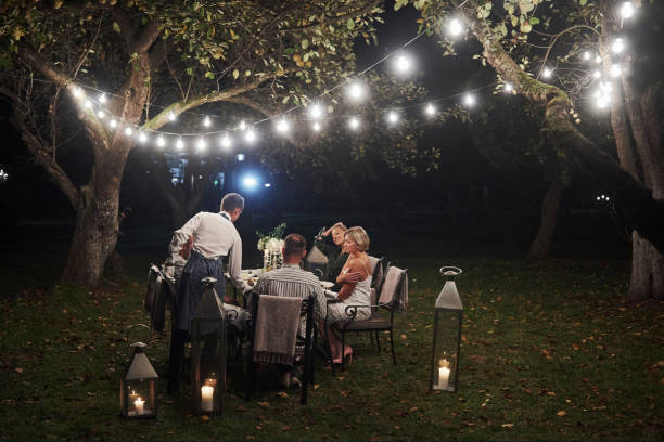 istock Guy brought an order. Friends have meeting at evening. Nice outside restaurant 1143016848