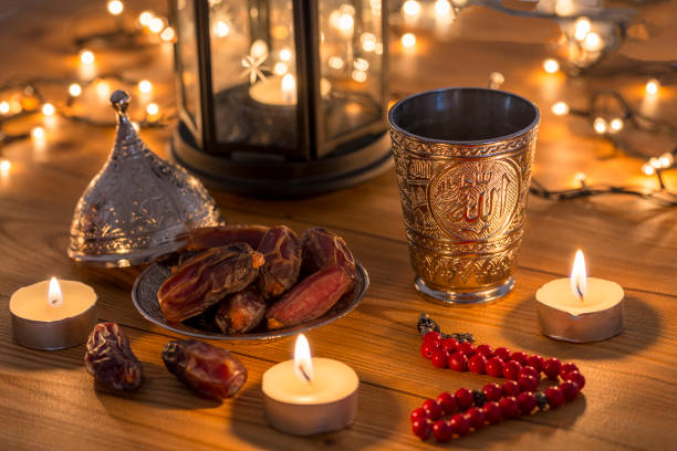 istock Ramadan concept with dates, rosary, and metal water cup with Allah text in Arabic 1143017068