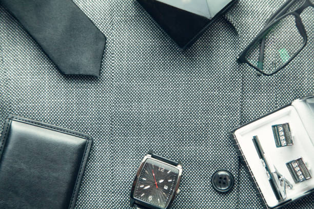 istock Cufflinks, wristwatch, perfume, wallet, glasses, tie in suit background. 1143017165