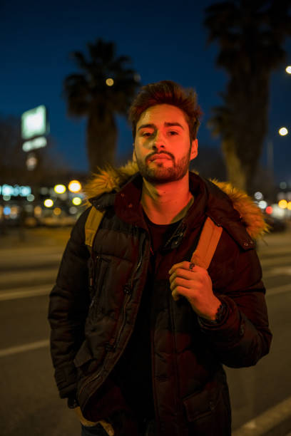 istock Cool young man crossing the street 1143017226