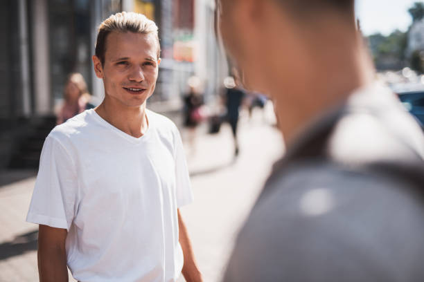 istock Positive male communicating with comrade in town 1143019122