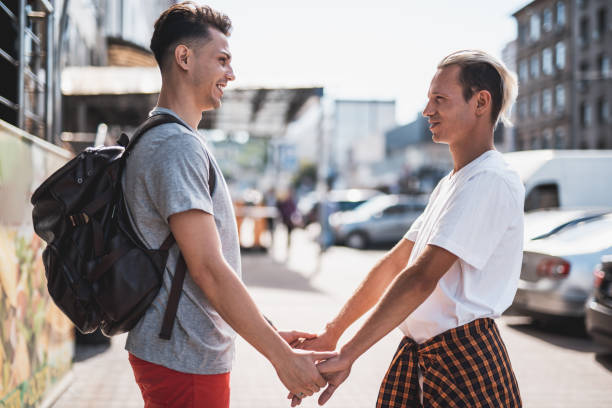 istock Cheerful men going along city during day 1143019123