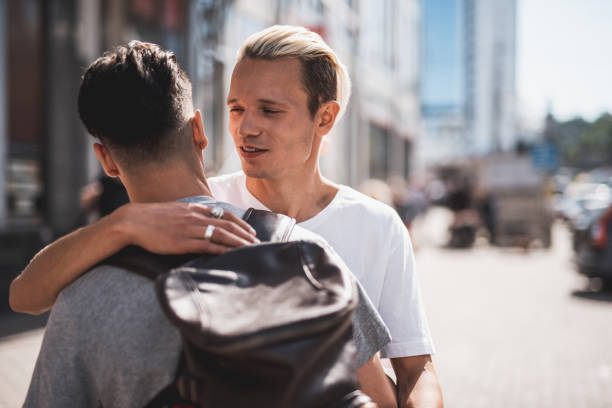 istock Optimistic man hugging comrade in the city 1143019136