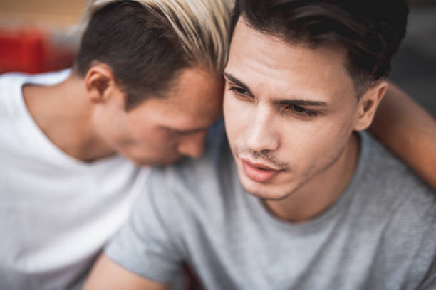 istock Sorrowful male telling with thoughtful comrade outdoor 1143019240