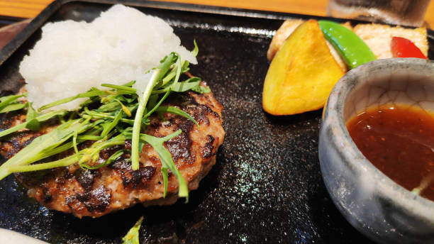 Hamburger meat in Japanese style served with fresh vegetable salad